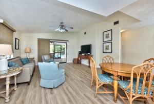 a living room with a table and a couch at Avanti Vacation Rental in Naples