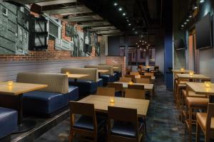 a restaurant with wooden tables and blue seats at Residence Inn by Marriott Baltimore Downtown/ Inner Harbor in Baltimore