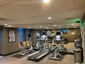 a gym with treadmills and ellipticals in a room at Atlantic Palace Beachfront Ocean View in Atlantic City