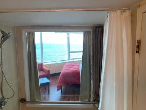 a bathroom with a window with a view of the ocean at Atlantic Palace Beachfront Ocean View in Atlantic City
