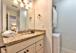 a bathroom with a sink and a mirror at Le Monaco Condo at Olde Naples in Naples