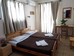 a bedroom with a bed with two towels on it at Tina Hotel in Chania Town