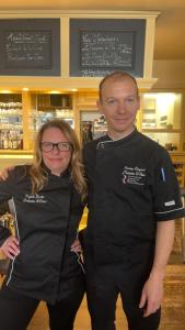 a man and a woman standing next to each other at H&ocirc;tel Restaurant L'Industrie in Saint-Omer