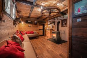 a living room with a couch and a fireplace at Tonkina koča in Kranjska Gora