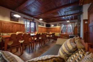 a dining room with a long table and chairs at Tonkina koča in Kranjska Gora
