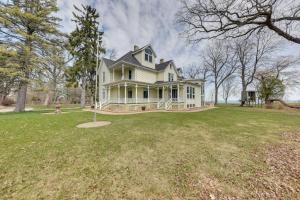 a large white house on a grass field at Lake Michigan Vacation Rental with Private Beach! in Racine