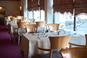 a row of tables and chairs in a restaurant at Cosmonaut in Karagandy