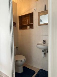 a bathroom with a toilet and a sink at L'art de vivre conjugué au calme in Balloy +7 photos