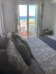 a bedroom with a bed with a view of the ocean at Residential Oasis 25 in Mojácar