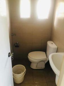 a bathroom with a toilet and a sink at Danarose residences rental in Bacoor