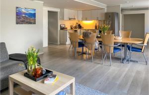 a living room and kitchen with a table and chairs at Awesome Apartment In Tresfjord With Wifi And 4 Bedrooms in Tresfjord
