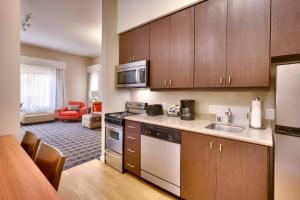 a kitchen with a sink and a stove top oven at TownePlace by Marriott Suites Elko in Elko