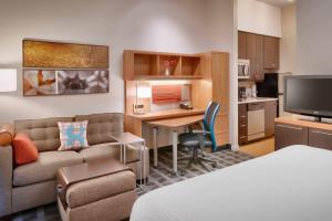 a living room with a couch and a desk in a room at TownePlace by Marriott Suites Elko in Elko