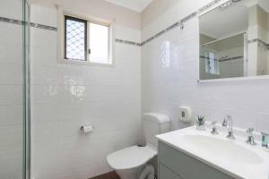 a bathroom with a toilet and a sink and a shower at Reflections Tuncurry - Holiday Park in Tuncurry