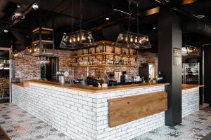 a brick wall with a bar in a restaurant at Original Sokos Hotel Koljonvirta in Iisalmi