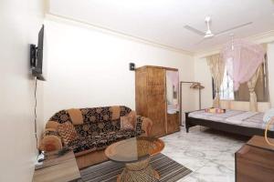 a living room with a couch and a table at Lux Suites Ganjoni Studio Apartment in Mombasa