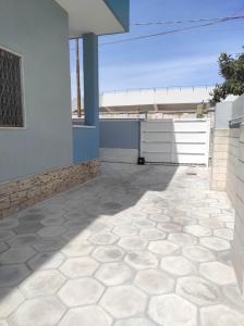 a patio with a tile floor and a building at Coco & Lisbeth bed and breakfast in Brindisi