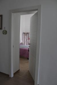 an open door to a bedroom with a bed at Coco & Lisbeth bed and breakfast in Brindisi