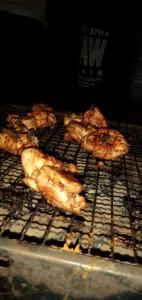 a group of chickens cooking on a grill at Brisk Ella Retreat in Ella