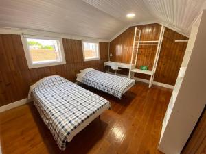 two beds in a room with wooden walls and wood floors at BREINER 28 in Porto