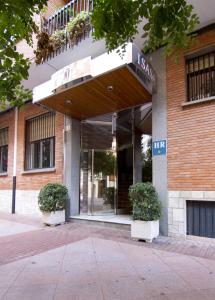 un edificio con dos macetas delante de él en Hotel Isasa en Logroño