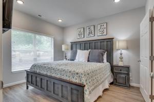 a bedroom with a large bed and a window at NEW 3 BR Apt ADA compliant Sleeps 8 in Pigeon Forge