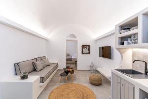 a white living room with a couch and a sink at AnnaFani Villa in Pyrgos