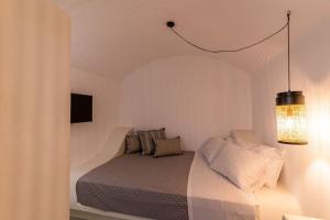 a bedroom with a bed and a chandelier at AnnaFani Villa in Pyrgos