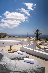 two pillows on a balcony with the ocean in the background at AnnaFani Villa in Pirgos