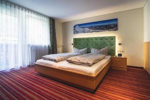 Posteľ alebo postele v izbe v ubytovaní Alpenherz Apartments