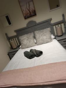 a bed with two towels laying on top of it at Bello Guest in Bloemfontein