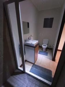 a bathroom with a sink and a toilet at Bello Guest in Bloemfontein