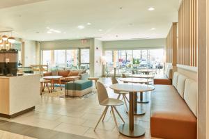 a restaurant with tables and chairs and a cafeteria at TownePlace Suites by Marriott Hixson in Hixson