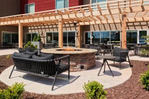 een patio met tafels en stoelen en een vuurplaats bij TownePlace Suites by Marriott Hixson in Hixson