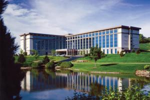 an office building with a lake in front of it at Milwaukee Marriott West in Waukesha