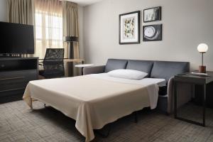 a hotel room with a bed and a television at Residence Inn Mount Olive At International Trade Center in Stanhope