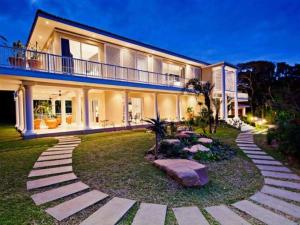 a large house with a garden in front of it at Eden Rock Forest Estate in Pennington