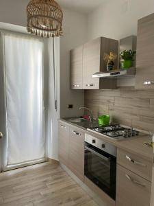 a kitchen with a stove top oven next to a window at B&B Emozione in Campobasso