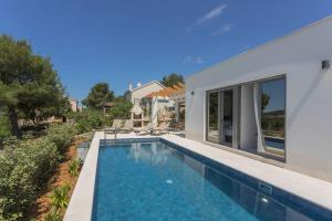 a swimming pool in front of a house at Sullago in Šibenik