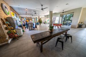 a room with a table and people in a store at Mad Monkey Hoi An in Hoi An