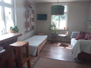 a living room with a bed and a couch at Pension-City-Kontor-Erfurt in Erfurt