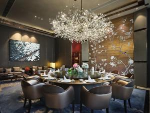 a dining room with a table and chairs and a chandelier at InterContinental Xiamen, an IHG Hotel in Xiamen
