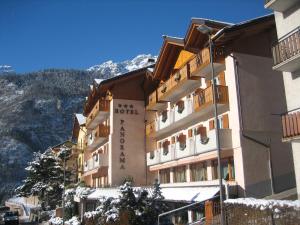 a building with a sign on the side of it at Hotel Panorama in Molveno