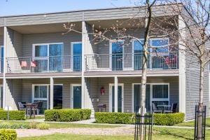 a house with a balcony and a patio at Ramios bitės in Palanga