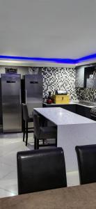 a kitchen with a table and chairs and appliances at Nandoni Crystal in Thohoyandou