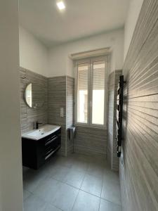 a bathroom with a sink and a mirror at Appart'Hôtel Sous Les Pins in Martigues