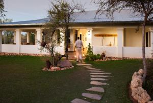 a man walking into a house at Onguma Tamboti Campsite in Namutoni