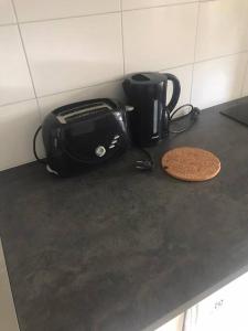 a counter top with a toaster and a coffee maker at Nice Entire Semi - Attached House - B in Umeå