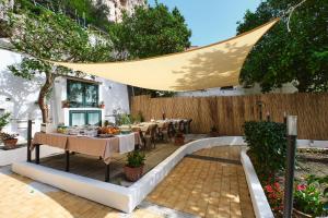 a patio with tables and chairs and a fence at Villa Fabiana in Amalfi