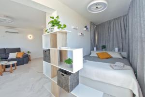 a bedroom with a bed with a book shelf at AZURE VIEW Ponderosa 719 in Playa Fañabe +36 photos